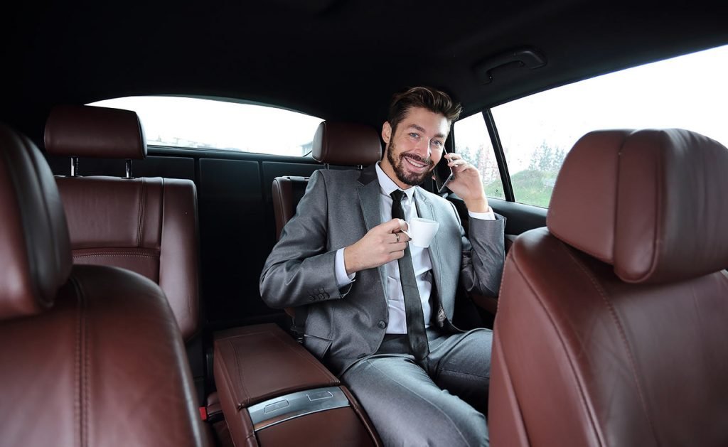 Business traveler inside an executive car
