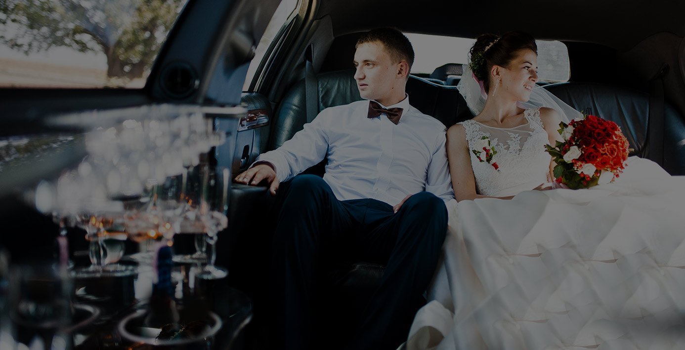 Bride and groom inside a limousine for Denver wedding transportation