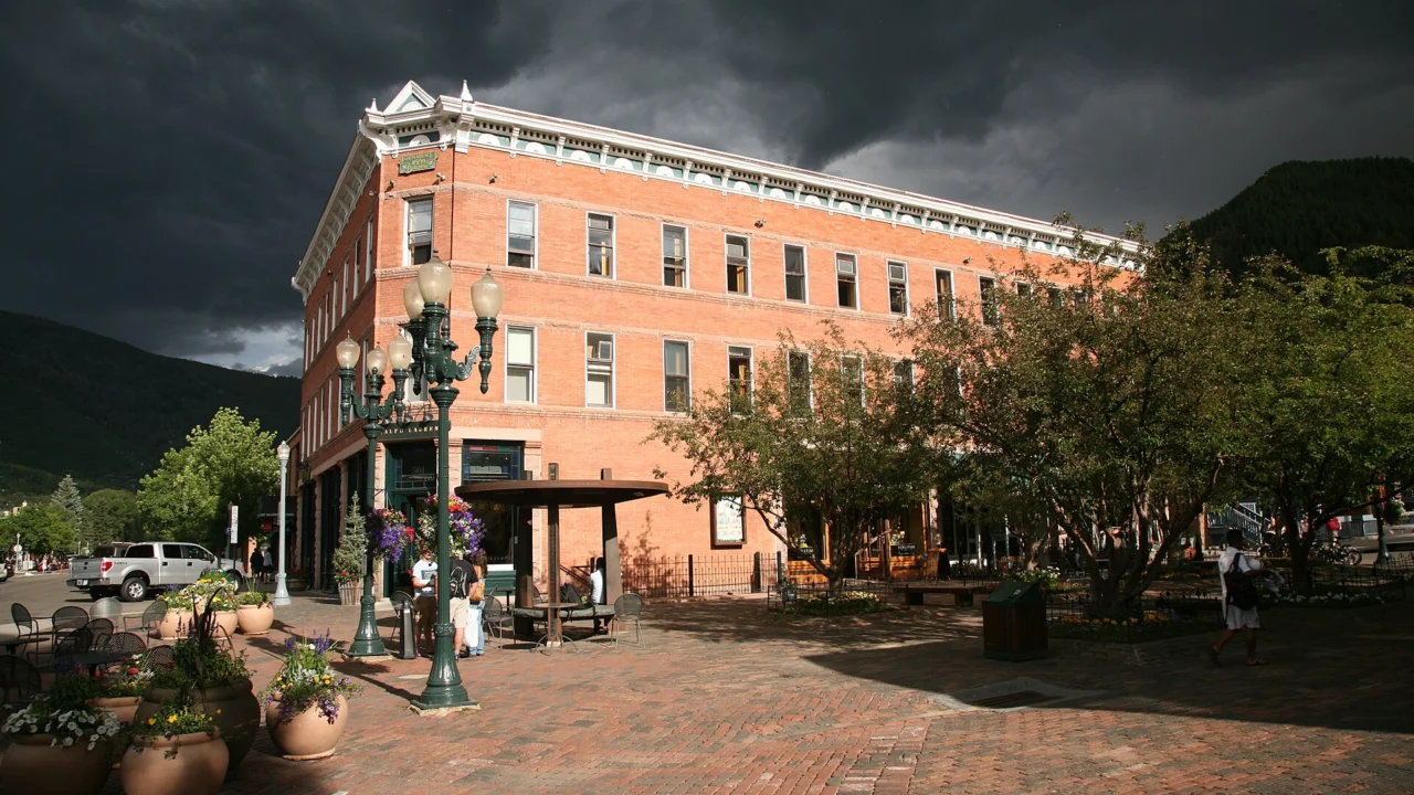 Historic downtown Aspen, Colorado, with mountain slopes beyond brick buildings